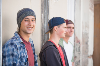 Three young guys smiling