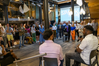 The audience watching our speaker panel at our anniversary event