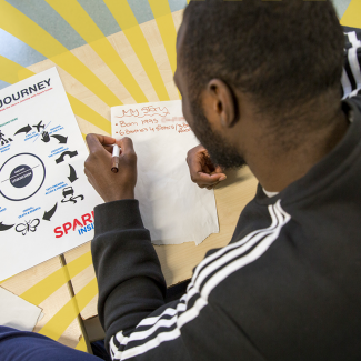 Young man writing with Hero's Journey model